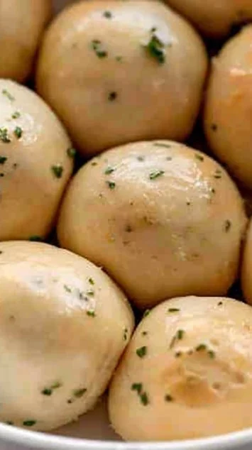 Freshly baked garlic bread rolls on a wooden table