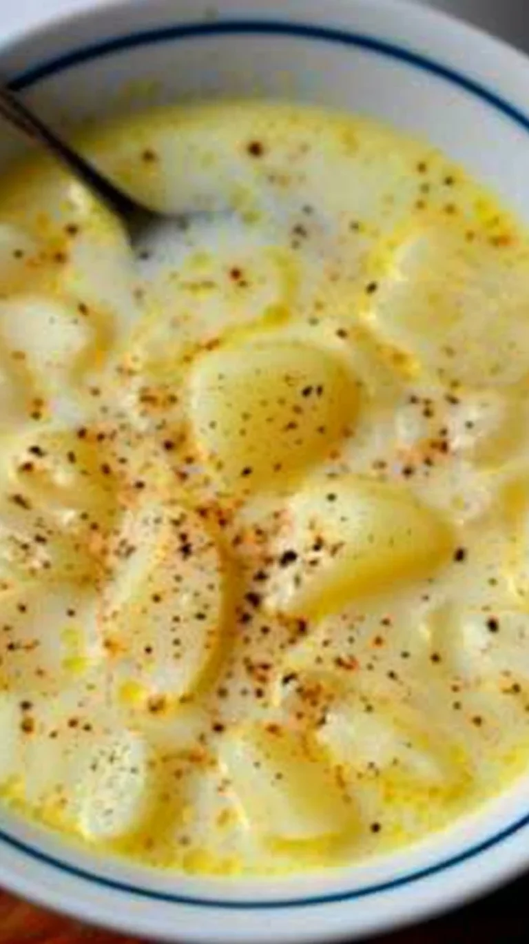 Bowl of Grandmother's homemade potato soup topped with fresh herbs