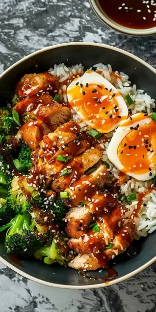 Sticky Chicken Rice Bowls with colorful vegetables and garnishes