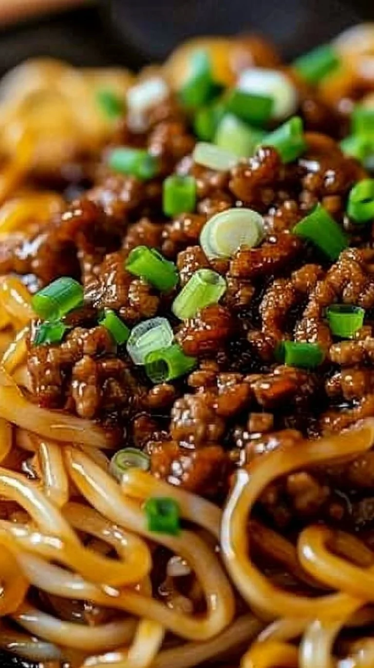 Delicious bowl of Mongolian Ground Beef Noodles topped with fresh herbs