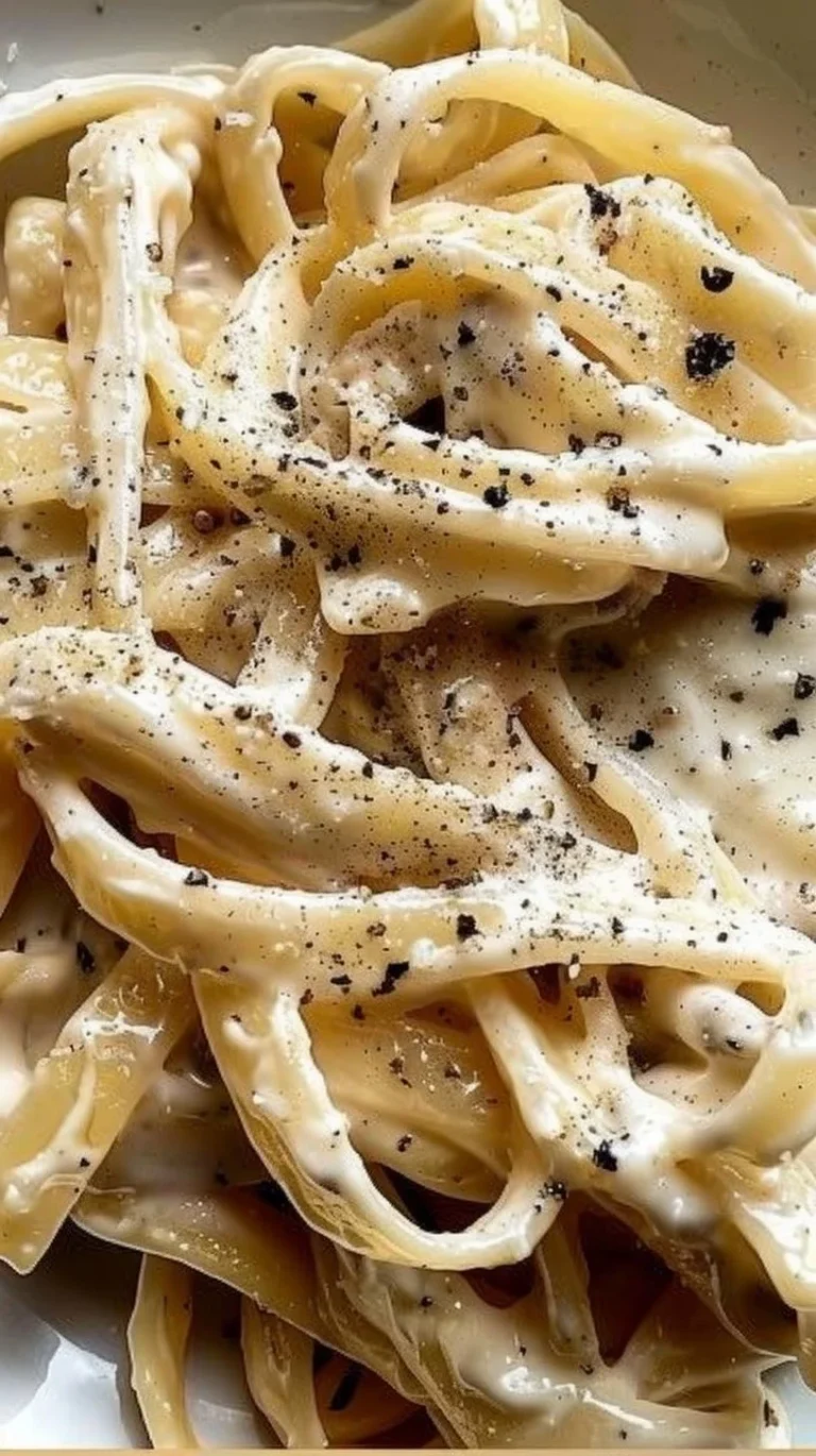 Delicious Greek yogurt Alfredo sauce served over pasta with fresh herbs.