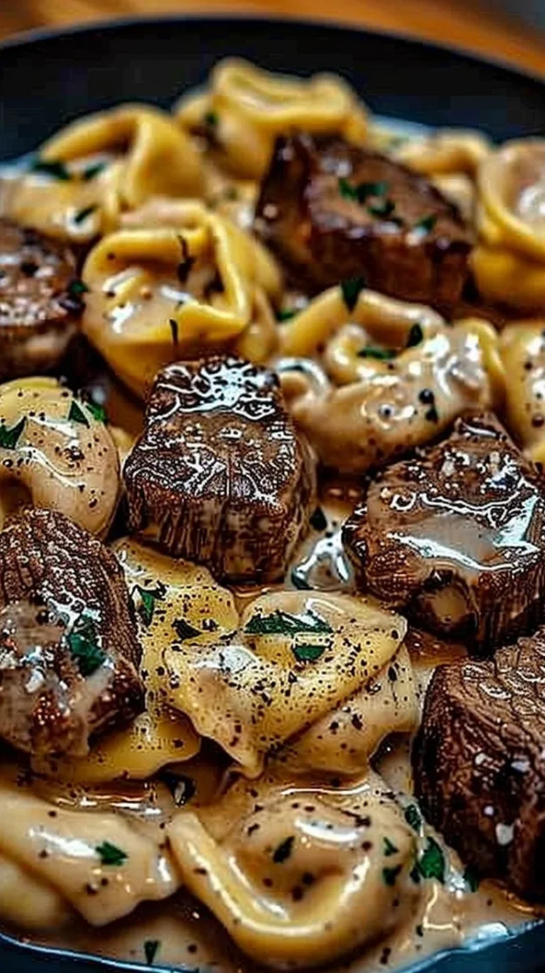 Cracked garlic steak tortellini in creamy sauce served on a plate
